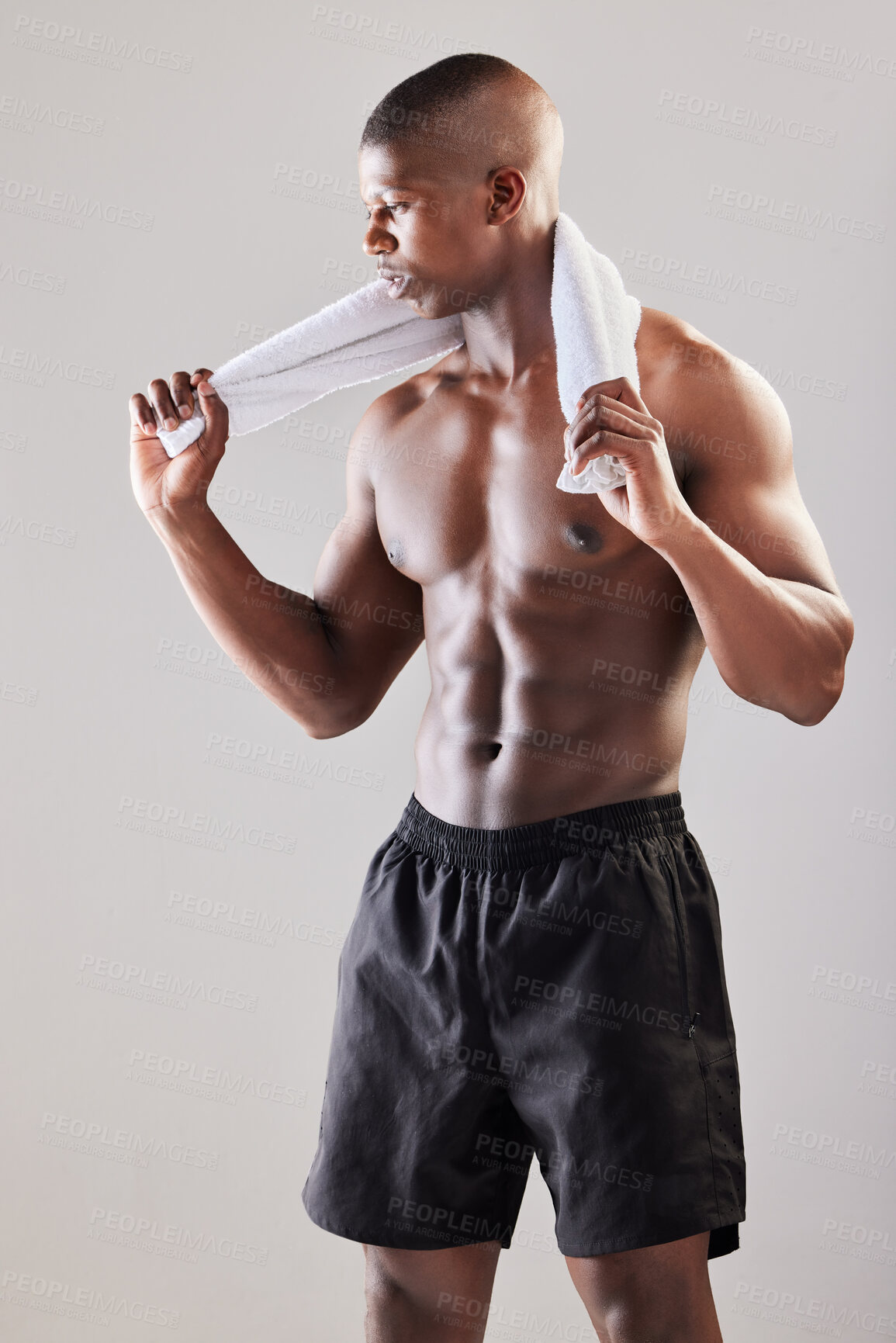 Buy stock photo Studio shot of a muscular young man posing against a grey background