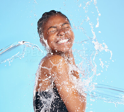 Buy stock photo Black woman, water and splash for cleaning face with hygiene, skincare and beauty care of hydrate glow. Studio, female person and natural facial, organic cosmetics and wellness on blue background