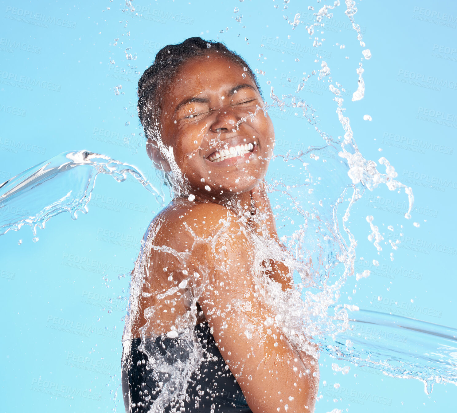 Buy stock photo Black woman, water and splash for cleaning face with hygiene, skincare and beauty care of hydrate glow. Studio, female person and natural facial, organic cosmetics and wellness on blue background