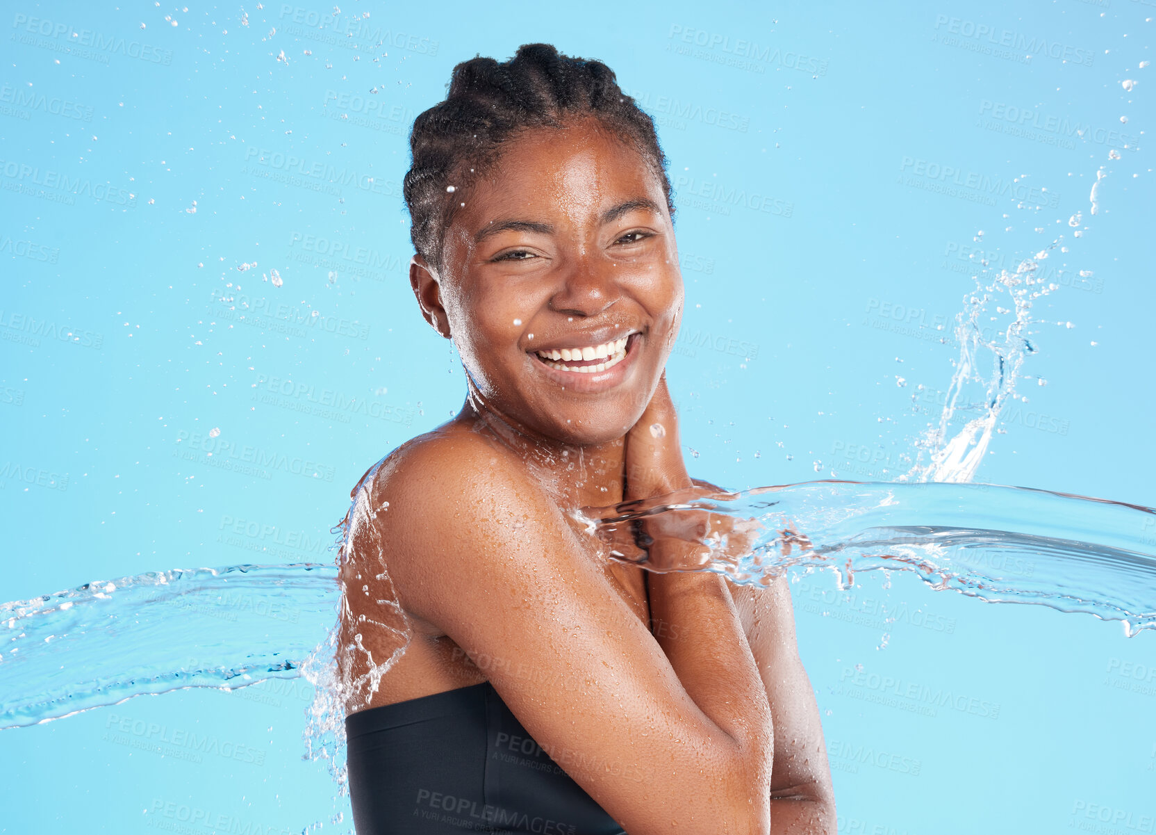 Buy stock photo Portrait, black woman and splash water in studio for cleaning face, hygiene and skincare beauty of hydrate glow. Smile, female person and natural facial, cosmetics and wellness on blue background