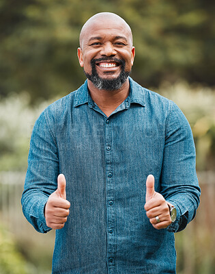 Buy stock photo Shot of a mature man giving the thumbs up in his garden