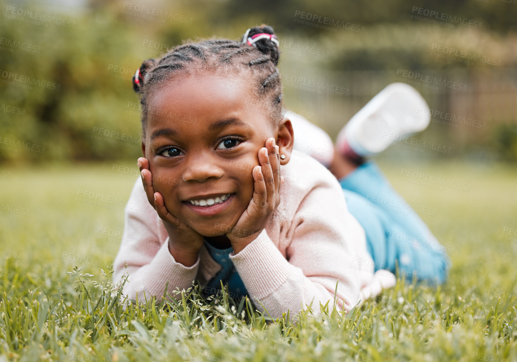 Buy stock photo Shot of a little girl lying on the grass in her yard