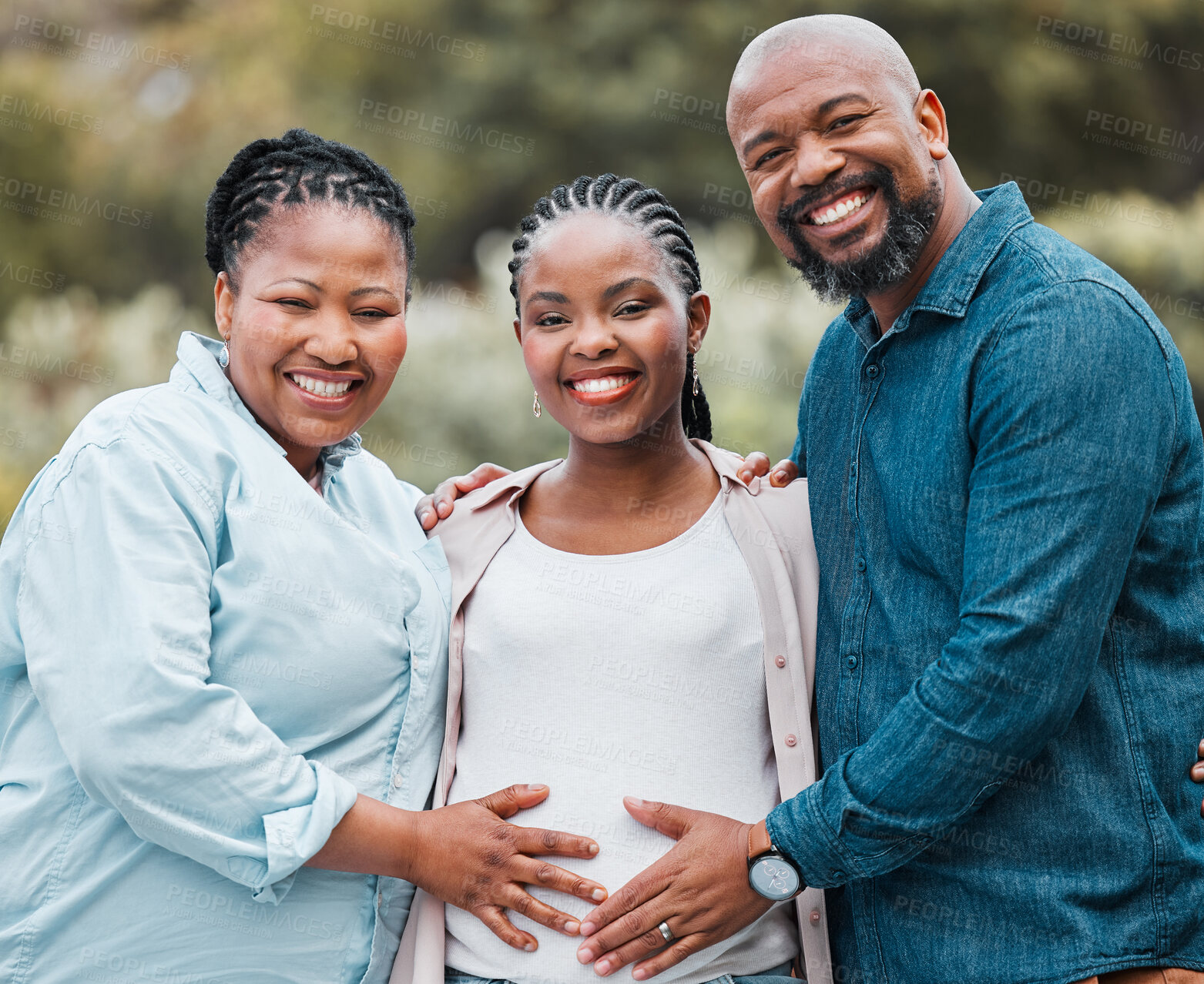 Buy stock photo Shot of a mother and father celebrating their daughter's pregnancy