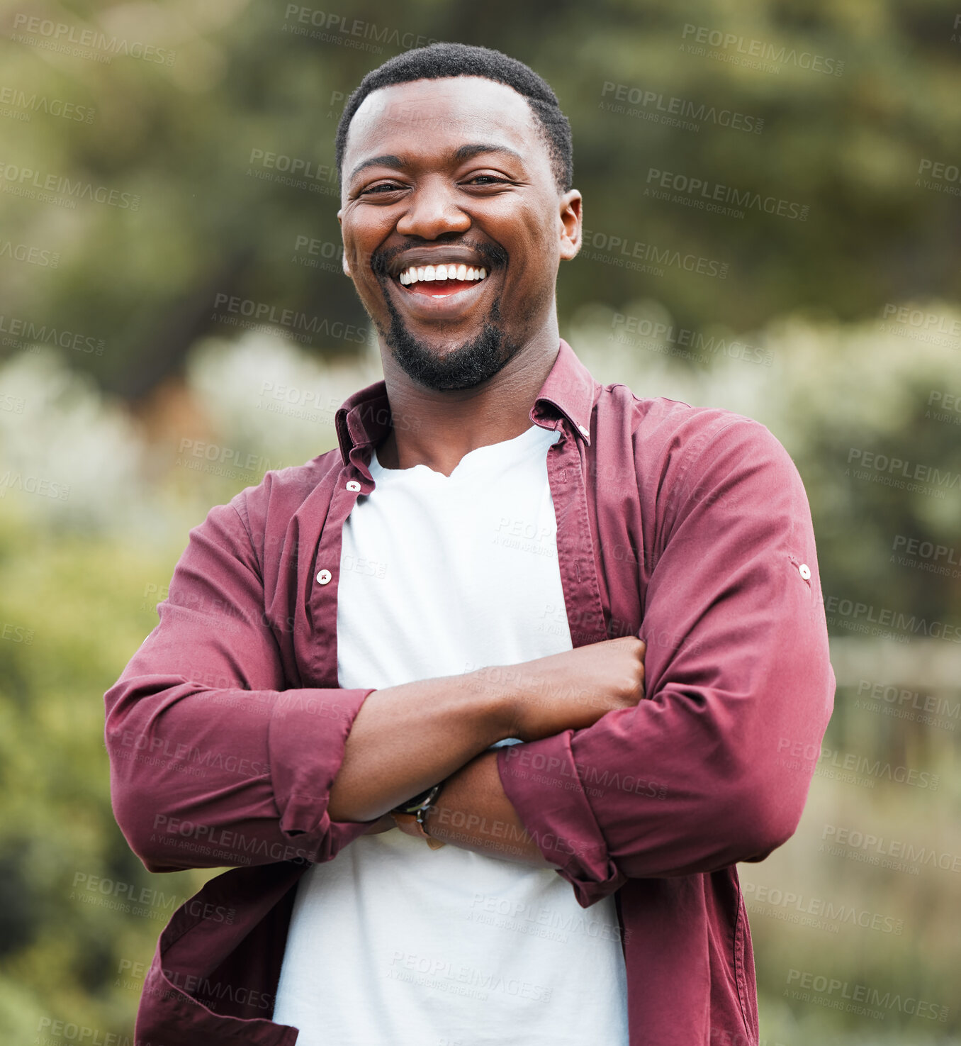 Buy stock photo Black man, portrait and outdoor with arms crossed in nature, forest and countryside in Nigeria. Male person, travel and laugh for humor on vacation, weekend trip and woods for funny joke on getaway