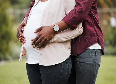 Buy stock photo Shot of a expecting couple posing together in their yard