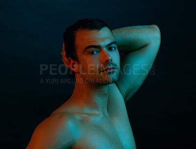 Buy stock photo Studio portrait of a handsome young man posing nude against a dark background