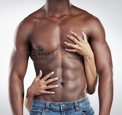 Buy stock photo Cropped shot of an unrecognisable man standing and posing shirtless while his girlfriend touches him