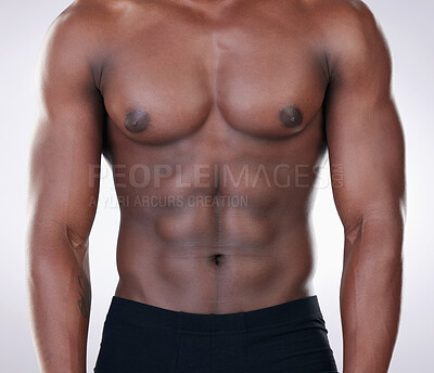 Buy stock photo Cropped shot of an unrecognisable man standing alone in the studio and posing shirtless