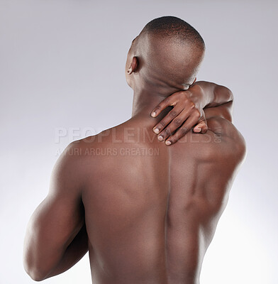 Buy stock photo Back pain, fitness and a black man feeling an injury isolated on a white background in a studio. Sport, muscle and an African person touching spine after exercise problem, body strain or tension