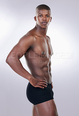 Buy stock photo Attractive, confidence and portrait of a shirtless man in a studio with a muscular body in underwear. Serious, fitness and young African male model with a strong and sexy figure by white background.