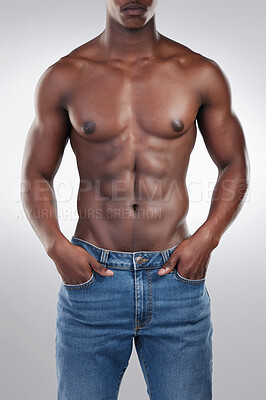 Buy stock photo Cropped shot of an unrecognisable man standing alone in the studio and posing shirtless