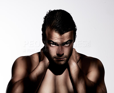 Buy stock photo Shot of a muscular young man posing against a studio background