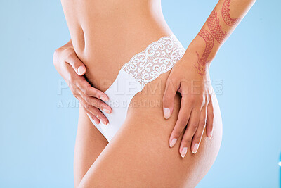 Buy stock photo Shot of an unrecognizable woman posing in her underwear against a blue background