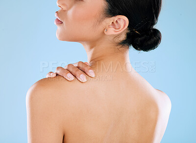 Buy stock photo Rearview shot of a young woman posing against a blue background