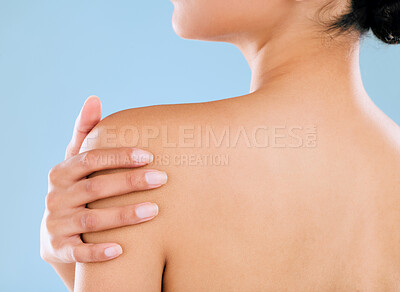 Buy stock photo Rearview shot of a young woman posing against a blue background