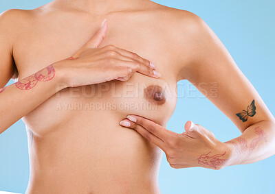 Buy stock photo Studio shot of an unrecognizable woman examining her breast