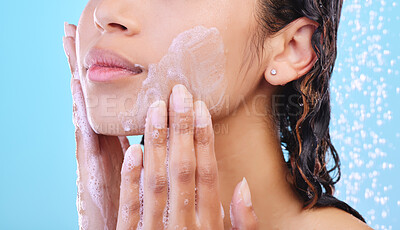 Buy stock photo Hands, facial skincare and shower in studio with foam, cleaning and hygiene for wellness by blue background. Woman, model or person with beauty, cosmetics and water drops for change with dermatology