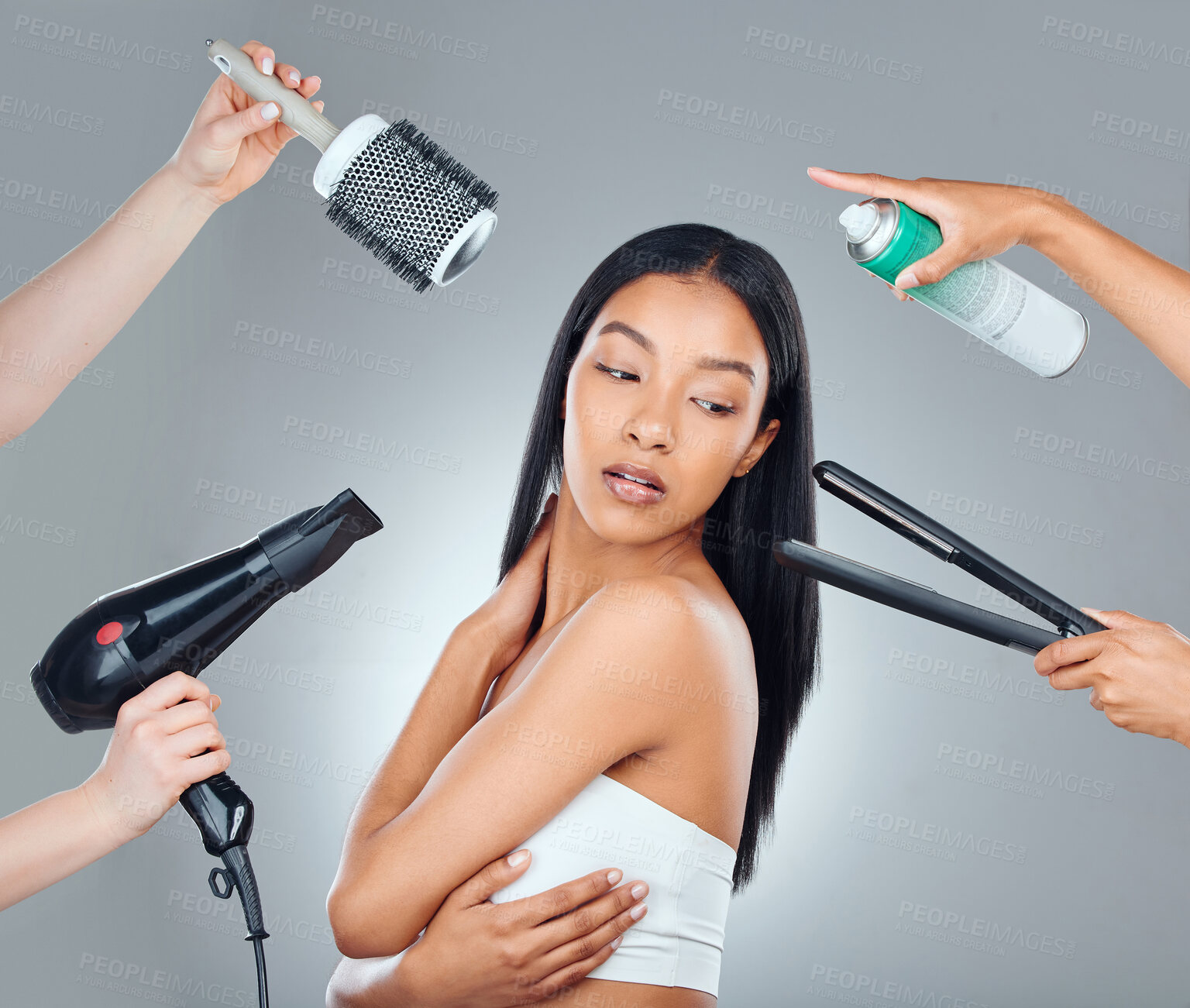 Buy stock photo Hair care, beauty and woman with hands of stylists isolated on a grey background in a studio. Thinking, brush and iron of workers for a young model at a salon for a touchup and grooming with product
