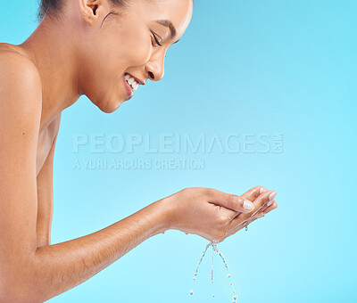 Buy stock photo Shot of an attractive young woman posing against a blue background while taking a shower