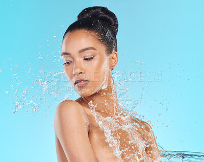 Buy stock photo Shot of an attractive young woman showering against a blue background