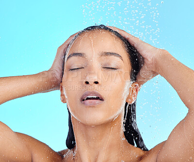 Buy stock photo Hair, shower and black woman in studio for skincare, wellness and grooming on blue background. Beauty, washing and hair care by girl model relax in water splash, cleaning and hygiene routine isolated