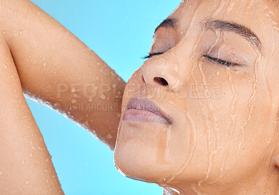 Buy stock photo Shower water, face and black woman cleaning body with liquid for hydration, beauty healthcare or skincare hygiene. Self care studio, spa salon girl and relax model washing isolated on blue background