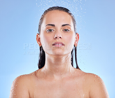 Buy stock photo Shot of a beautiful young woman enjoying a refreshing shower against a blue background