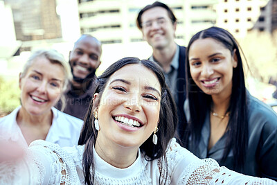 Buy stock photo Shot of a group of business colleagues taking selfies outside