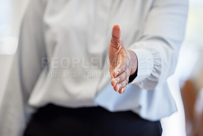 Buy stock photo Cropped shot of an unrecognisable businesswoman standing alone in the office and extending her hand for a handshake