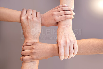 Buy stock photo Shot of a group of unrecognizable businesspeople connecting their arms
