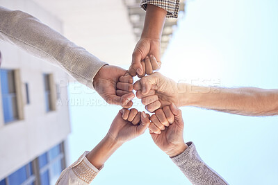 Buy stock photo Low angle shot of a group of unrecognizable businesspeople giving each other a fist bump