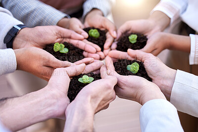 Buy stock photo Shot of a group of unrecognizable businesspeople holding plants in soil at work