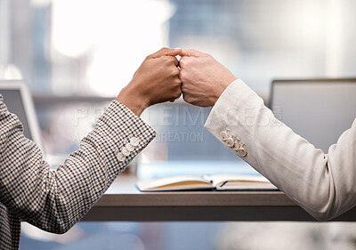 Buy stock photo Shot of two businesswomen fist bumping one another