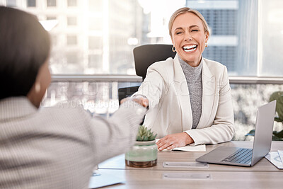 Buy stock photo Shot of a young businesswoman shaking hands with a fellow staff member