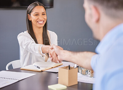 Buy stock photo Shot of a young businesswoman shaking hands with a colleague in an office