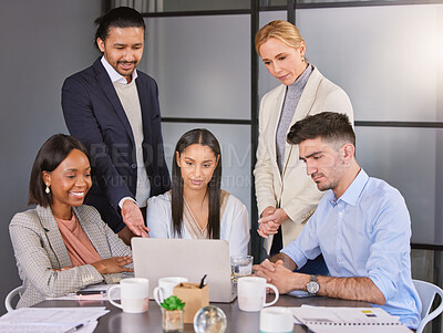 Buy stock photo Shot of a group of businesspeople working together on a laptop in an office
