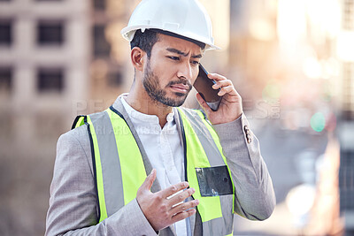 Buy stock photo Cropped shot of a handsome male construction worker making a call while standing on a building site