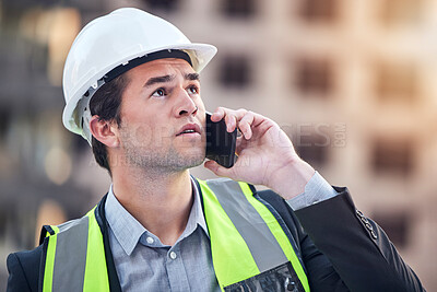 Buy stock photo Cropped shot of a handsome male construction worker making a call while standing on a building site