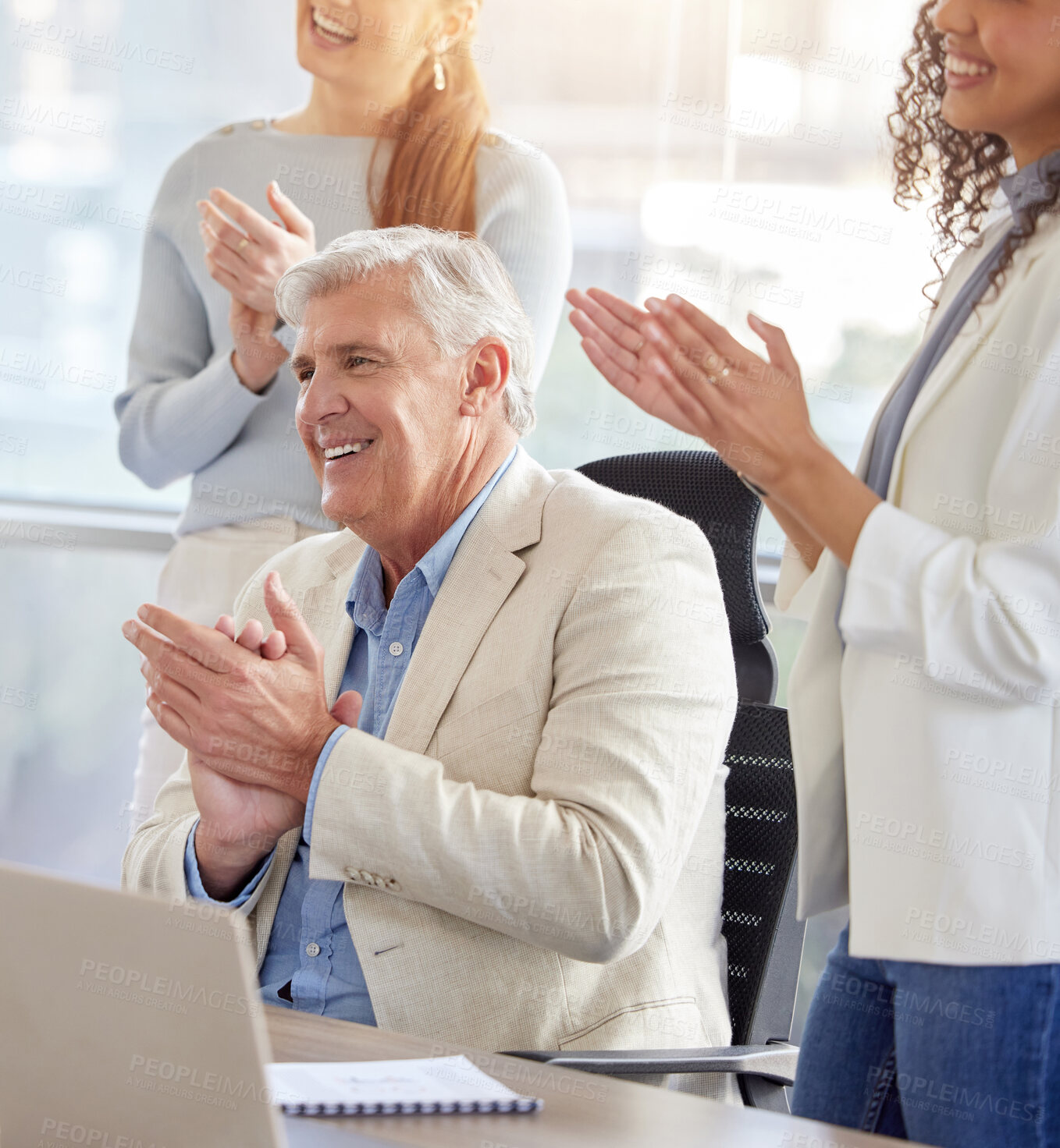 Buy stock photo Shot of a diverse group of businesspeople clapping and celebrating a success in the office