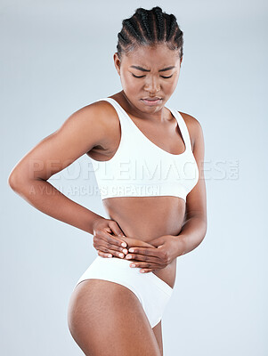 Buy stock photo Shot of a young woman pulling the skin on her waist