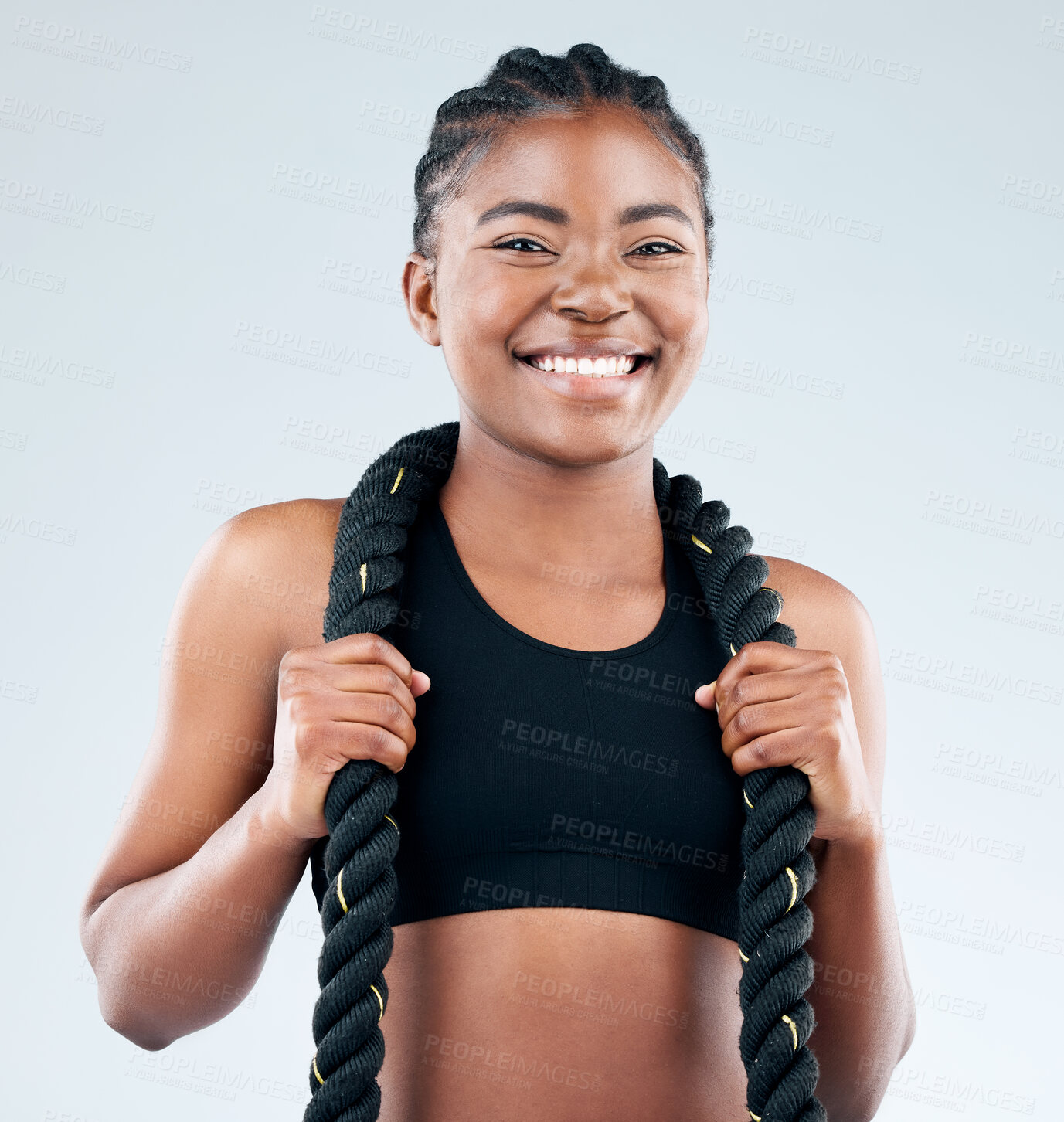 Buy stock photo Portrait, African woman and battle rope for health, fitness and exercise in white background with happiness. Black, female person and excited for workout, training or cardio as athlete in studio