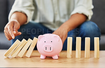 Buy stock photo Shot of a unrecognizable man playing with blocks and a piggy bank on a table