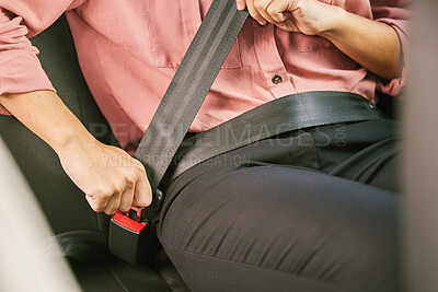 Buy stock photo Shot of a unrecognizable woman fastening her seatbelt in a car