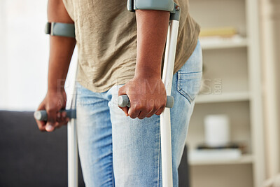Buy stock photo Shot of a unrecognizable man using crutches at home