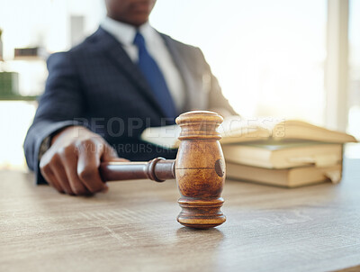 Buy stock photo Shot of an unrecognizable lawyer using a gavel at work