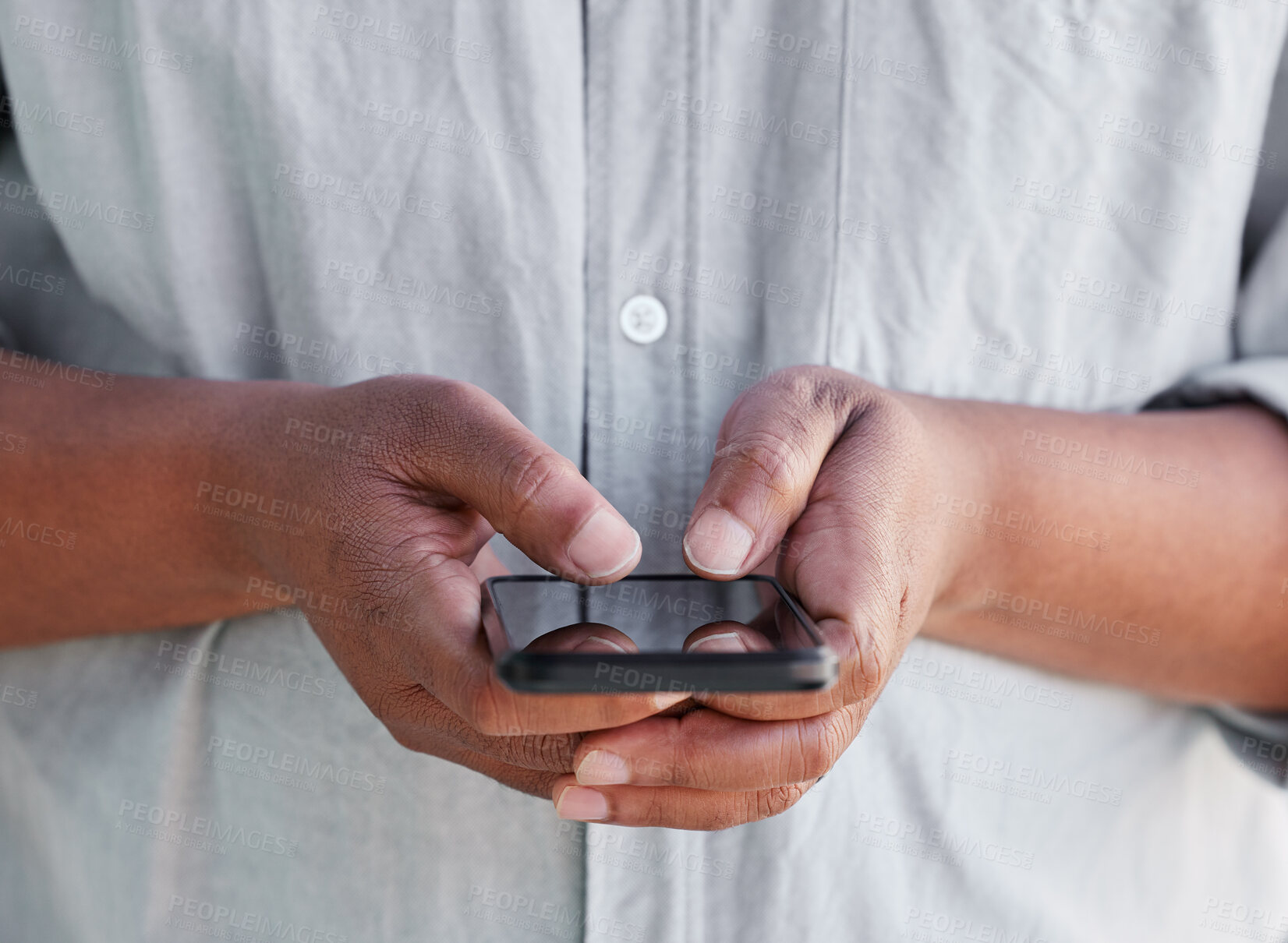 Buy stock photo Shot of an unrecognisable man using a smartphone