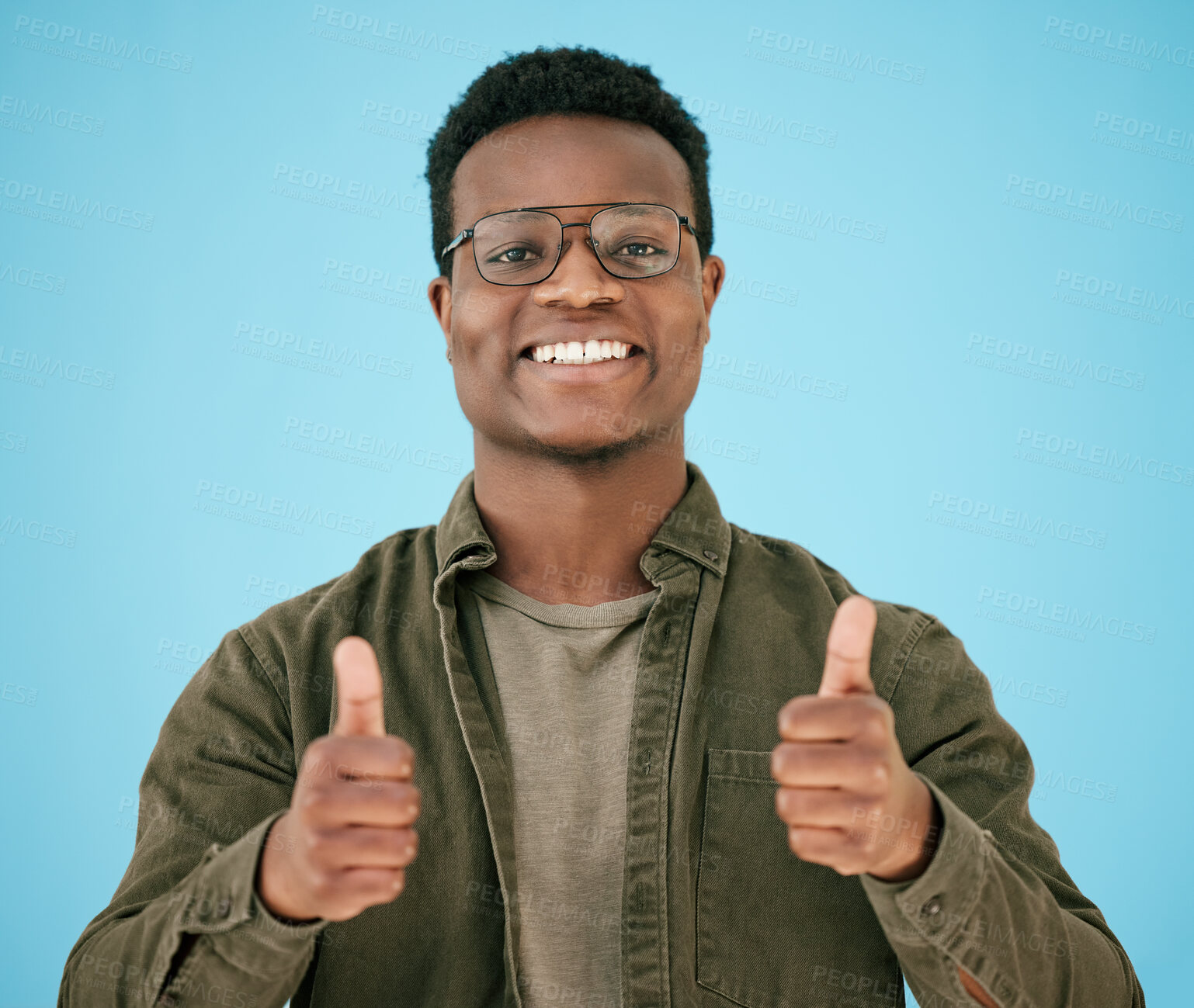 Buy stock photo Portrait, smile and black man with thumbs up in studio for thank you, winner support and agreement of announcement. Happy, African person and glasses with hand gesture, yes sign and blue background