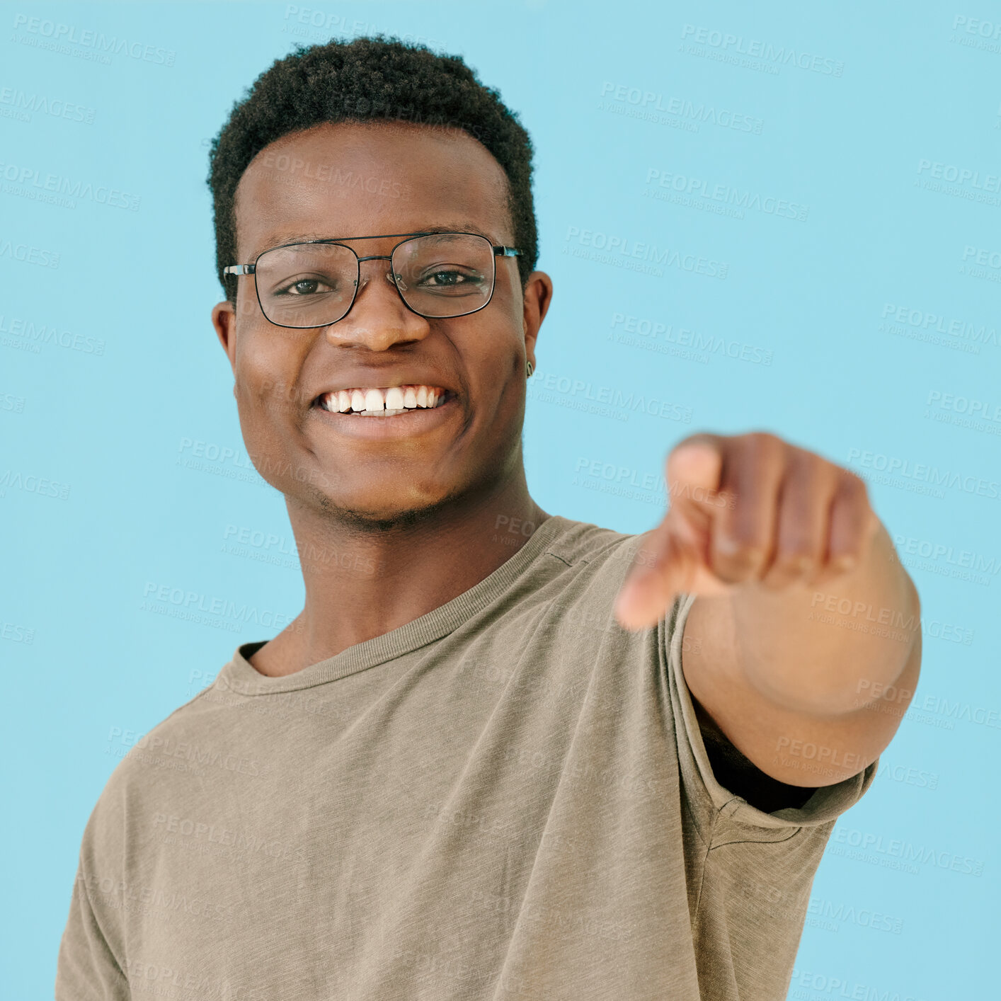 Buy stock photo Glasses, pointing and portrait with black man on blue background in studio for announcement or promotion. Face, marketing and smile with happy person showing information, news or notification