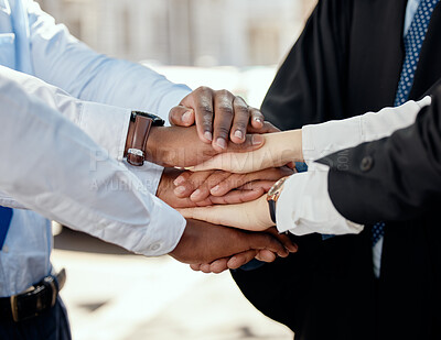 Buy stock photo Shot of a group of unrecognizable businesspeople stacking their hands in the city