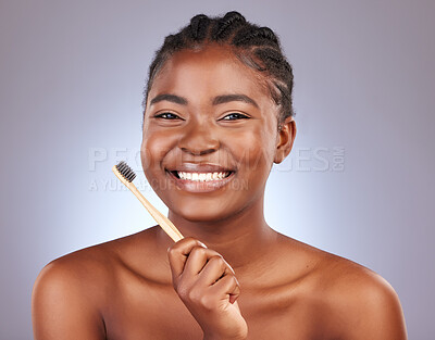 Buy stock photo Bamboo toothbrush, portrait and woman in studio with oral health, morning and wellness routine. Smile, hygiene and female person clean teeth for dental treatment with fresh breath by gray background.